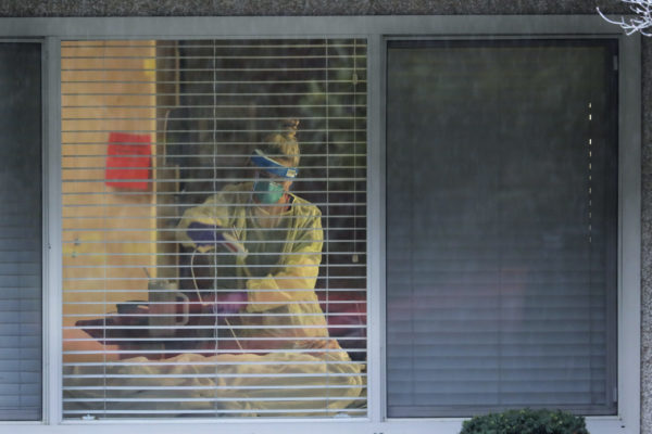 A nurse cares for a COVID patient at the Life Care Center in Kirkland, Washington, in March 2020
