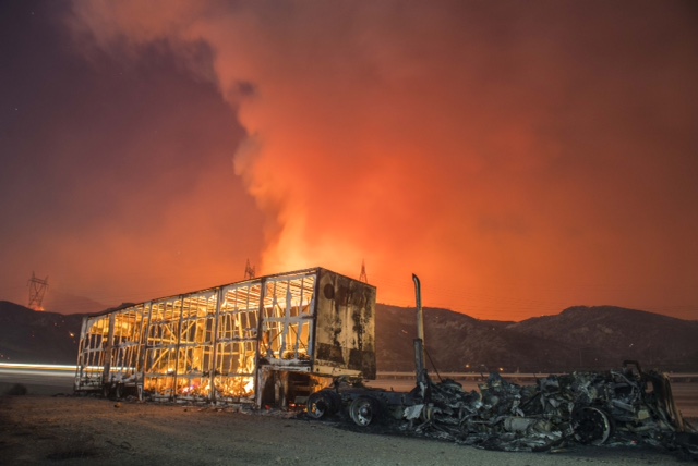 A smoldering moving van sits in the wake of the Blue Cut fire that burned across Interstate 15 north of San Bernardino, Calif. 8:59pm. 13 seconds with 24mm lens @f.5.6 