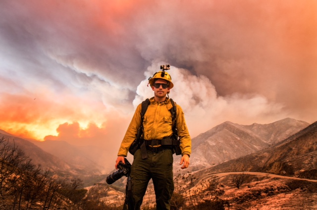Photojournalist Stuart Palley, dressed in fire resistant clothing, stands upwind during the Sand Fire on Little Tijunga Canyon Rd north of Los Angeles. 